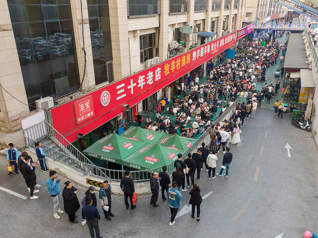 2023年3月31日，山东淄博，一家网红烧烤店，里面座无虚席，外面的食客们已排成长龙。视觉中国图