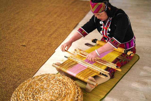 4月17日，黎族传统纺染织绣技艺国家级代表性传承人刘香兰在2023年意大利米兰设计周上展示黎锦织造技艺。