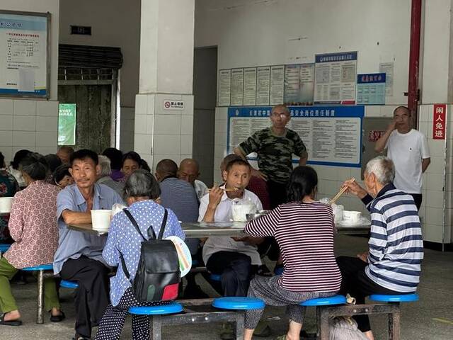 长滩初级中学安置点群众正在用午饭。新华社记者李晓婷摄
