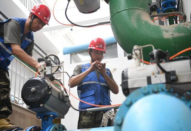 8月8日，工作人员在涿州市城区地表水厂设备间抢修受损设备。新华社记者朱旭东摄