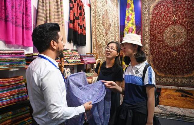 8月17日，参观者在交流合作馆尼泊尔展区了解特色商品。新华社记者邹竞一摄