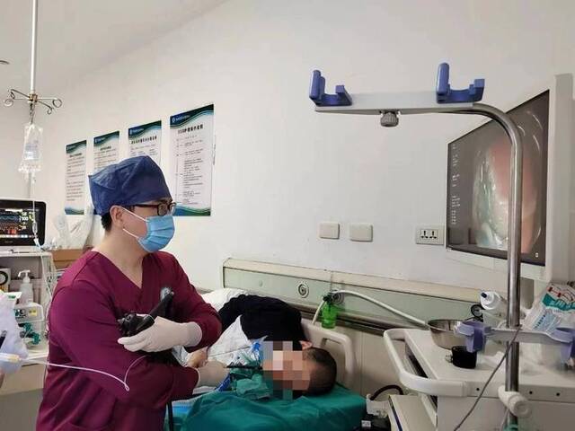 一名陆军军医大学西南医院医生正在为患者做胃镜检查。（受访单位供图）