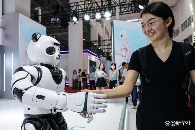 ↑8月16日，一名女士在北京举办的2023世界机器人大会现场与智能机器人握手。新华社记者彭子洋摄