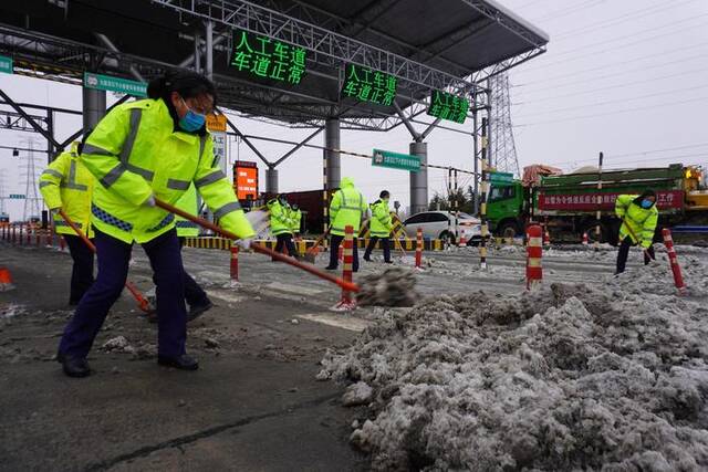 ▲2月1日，工作人员在郑州机场高速郑州南站清除积雪据视觉中国