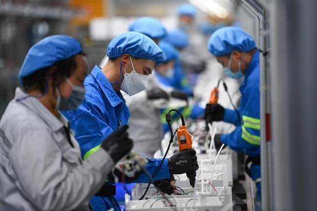 ▲工人在浙江某企业生产车间组装家用净水产品。图/新华社