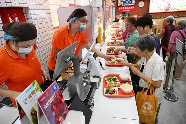 老人正在广州桐乐社区饭堂挑选餐品（7月24日摄）。新华社记者李贺摄